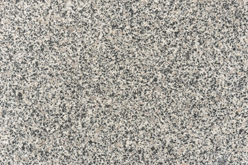 Natural gray granite with black spots, background.