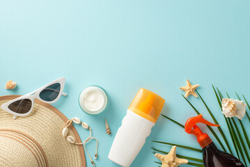 Healthy summer tan concept. Top view photo of empty space above sunscreen bottles, tubes, sprays and cream, shells and sunglasses with sunhat on blue isolated background with copy-space