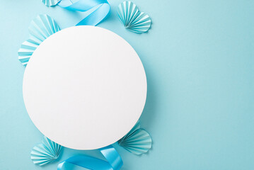 Top view photo of white empty circle with a pastel blue ribbon and origami paper hearts on an isolated light background with copy-space