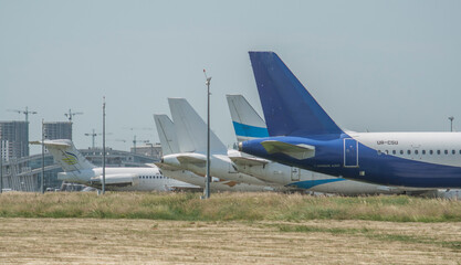 The keels of civilian airliners stand in a row in the parking lot of the airport in the summer. Tourism, civil aviation