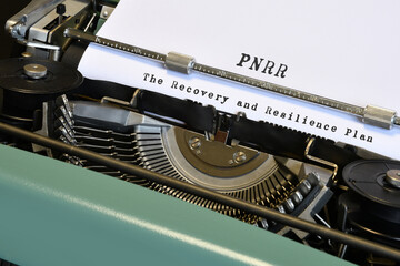 words 'PNRR The National Recovery and Resilience Plan' typed on vintage typewriter. The National...