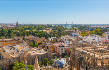 Obraz premium Seville's Aerial Tapestry: Cathedral Rooftop, Royal Alcazars, and the Majestic María Luisa Park