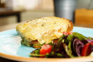 Classic french toast with cheese and ham, vegetables and honey-balsam dressing