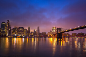 Panoramic view on Manhattan and Brooklyn bridge at night, New York City
