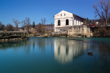 Fototapeta na wymiar Old abandoned hydro power plant on Vrbas river in Banja Luka, built in 1899