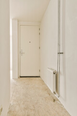 an empty room with no one on the floor and white walls, there is a door in the corner that leads to another room