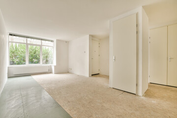 an empty room with white walls and floorboards on the wall, there is no one in the room to be seen