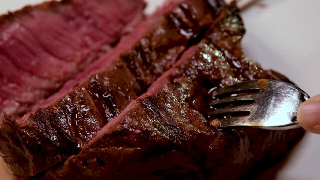 barbecue fresh beef meat with blood steak serving delicious food cut with knife several videos of one process of cooking delicious bbq steak
