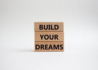 Dreams symbol. Concept word Build your Dreams on wooden blocks. Beautiful white background. Business and Build your Dreams concept. Copy space