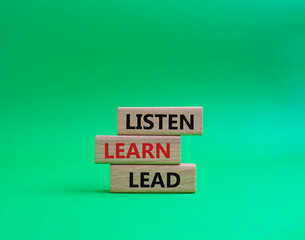 Listen Learn Lead symbol. Concept words Listen Learn Lead on wooden blocks. Beautiful green background. Business and Listen Learn Lead concept. Copy space.