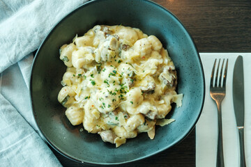 Gnocchi with mushroom, parsley and parmesan cheese in cream sauce - italian food style 