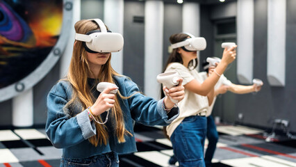 A group of teenagers wearing VR equipment