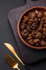 Delicious champignon mushrooms with salt, spices and herbs