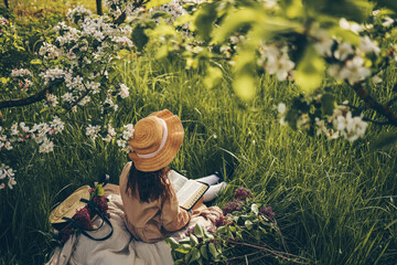 Girl reading the bible in the garden, christian concept
