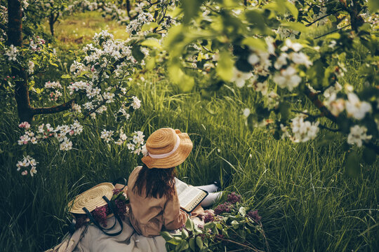 Girl reading the bible in the garden, christian concept