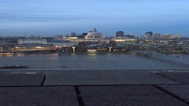 time-lapse of London skyline across Thames river London UK, millennium bridge St. Pauls cathedral sky scrapers