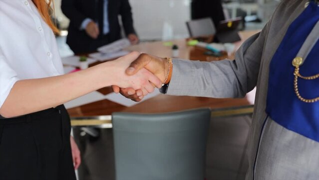Handshake between an African businessman and a Caucasian woman, international business