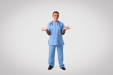 Happy caucasian senior doctor surgeon in blue uniform hold free space on hands