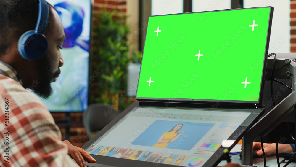 Poster male employee working with greenscreen and retouching software, looking at isolated mockup template 
