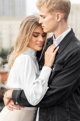 Beautiful happy young loving couple on a surprise date on a Saint Valentine's Day. Romantic modern wedding on the rooftop, summertime. Young man and beautiful girl. Newlyweds on honeymoon boho style