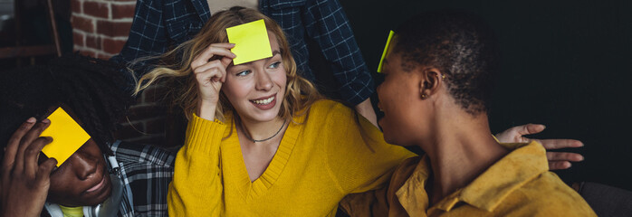 Diverse group of young people, friends, college students gathering together, have fun, playing games, laughing. Concept of diversity, international friendship, foreign languages, university. Banner