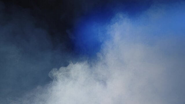 Clouds of smoke moving on a blue background