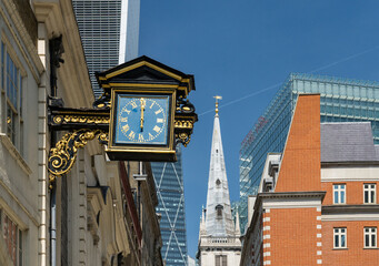 Fototapeta na wymiar Old traditional city buildings with antique clock on St Mary at Hill street in London