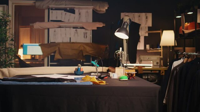 Empty tailor atelier with sewing tools and workstation, workshop used to design custom made clothes and fashion items. Textile industry equipment and craftsmanship, small business.