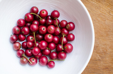 Jamaica cherries on a wooden background