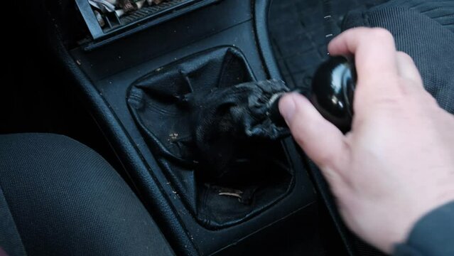 a man's hand pulls the gear shift knob in an old car. Vehicle malfunction. Manual Transmission.