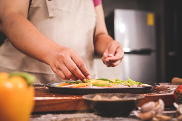 Fat female chef making traditional Italian pizza in home kitchen. fast food, healthy food