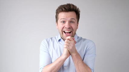 European young man is greatly surprised and opens his mouth in astonishment