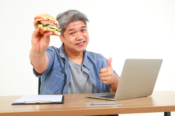 Asian fat man smiling happy Work while eating fast food as well. White background. Fast food...