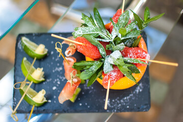 food for a buffet table, for cocktails, lime cheese, grapefruit with mint for a diet