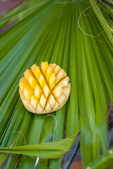 Sliced pineapple with palm leaf
