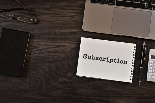 There is notebook with the word Subscription. It is as an eye-catching image.