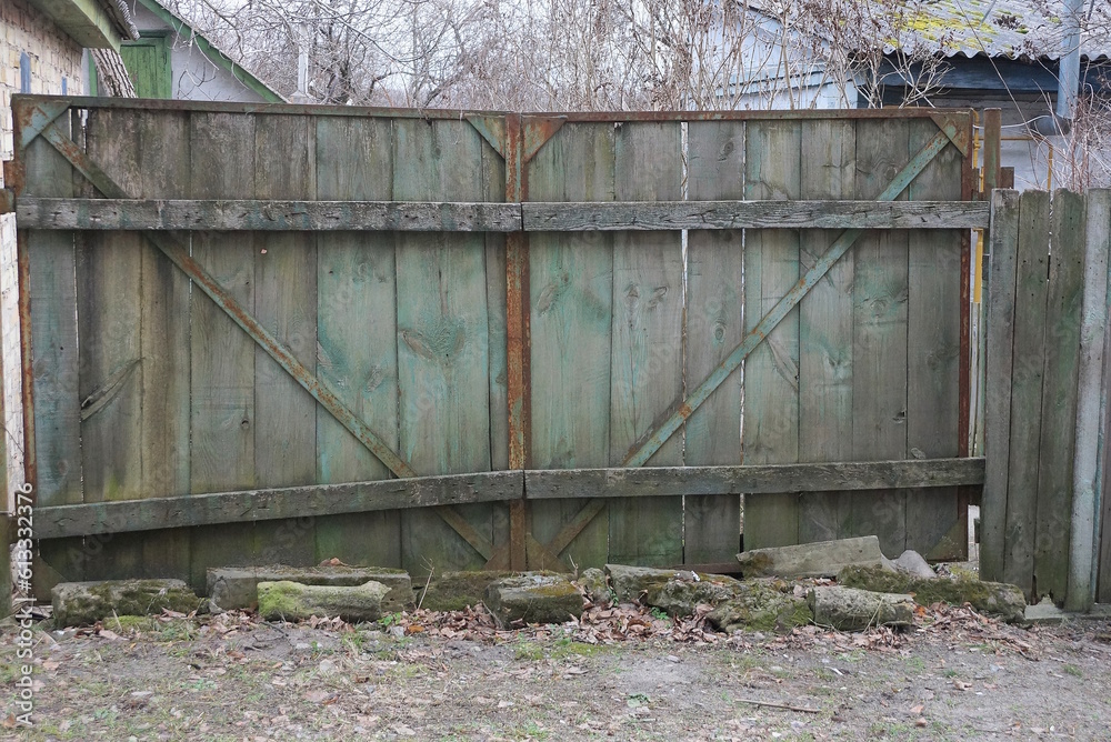 Canvas Prints one old closed gray green wooden gate on a rural street