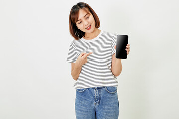 Satisfied smiling asian young woman recommending mobile phone app, website company on a smartphone, showing screen on white background.