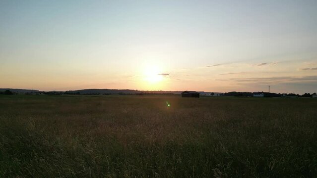 Germany, Bavaria, Allgaeu, drone flight over the meadow in the sunset