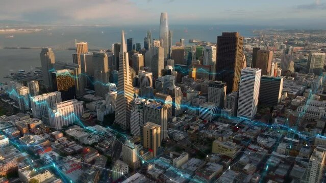 Group of business downtown skyscrapers lit by golden hour sunshine. Digital lines and charts, analysing collected data visual effects. San Francisco, California, USA