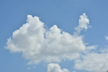 Naklejka na ściany i meble White clouds against blue sky for a backgrounds.