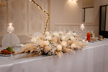 Boho wedding table set. vintage dining table with decorations, flowers and pampas grass Boho style. Table set for an event, party, date or wedding.