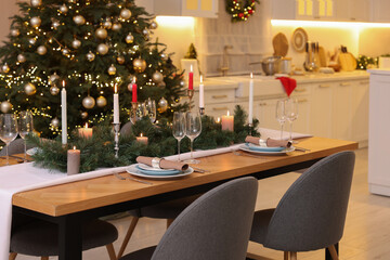 Festive table setting and beautiful Christmas decor in kitchen. Interior design