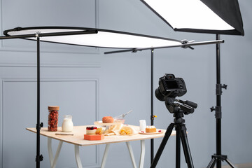 Professional equipment and composition with delicious desserts on wooden table in studio. Food...