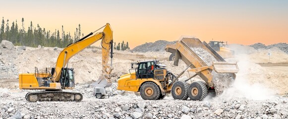 Excavator and dumpers working in a quarry at sunset with dust