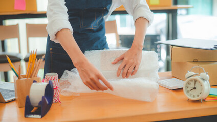 Online small business owners are packing their ordered products into the boxes for their customers based on the concept of online shopping - online shopping.