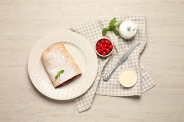 Delicious strudel with cherries on white wooden table, flat lay
