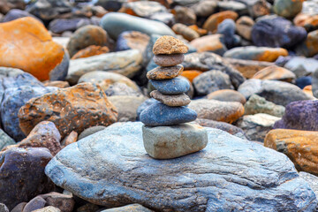 Fototapeta na wymiar Balanced stones on the beach . Coastal rocks and stones