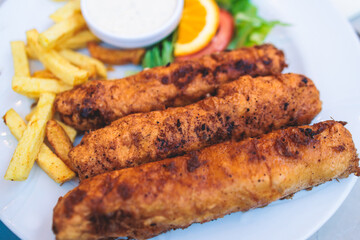 Podgoricki Popeci or Podgorica Popeci, veal fritters wrapped with prosciutto and cheese, served in...