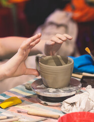 Pottery lesson master class for kids children, process of making clay pot on pottery wheel, potter wet hands creating ceramic crockery handcrafts, ceramist molding jar or vase